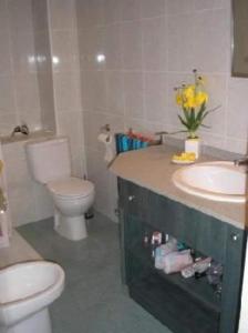 a bathroom with a toilet and a sink and a toilet istg at Costadaurada2000 Sunset Beach Cunit in Cunit