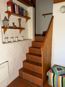 a staircase in a house with a book shelf at Rustico Marietta by HolAp SA in Brissago