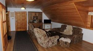 a living room with two chairs and a couch at Apartmán Belko in Hrádek