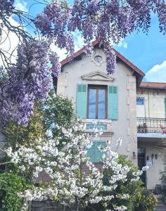 a house with a flowering tree in front of it at QG Marseille in Marseille