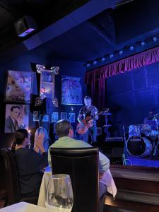 a group of people sitting in a room with a man playing guitar at Hotel Utopía by MA 22 Puntos in Benalup Casas Viejas +199 photos