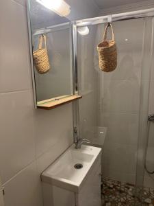 a white bathroom with a sink and a mirror at Tiny Diamond in Plomari +16 photos