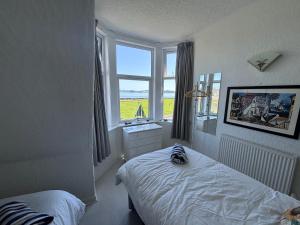 a bedroom with a bed and a large window at Fairview Millport in Millport