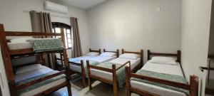a group of four bunk beds in a room at Chácara Umbelina Hospedaria in Cachoeira Paulista