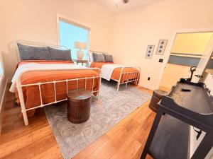 a bedroom with two beds and a window at Lakefront Villa with Dock Swim Platform in Lake Ozark