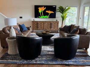 a living room with couches and a rug at Lakefront Villa with Dock Swim Platform in Lake Ozark