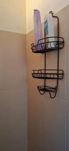 a bathroom with a shelf with toiletries on a wall at CHIK Coatepec Comfort in Coatepec