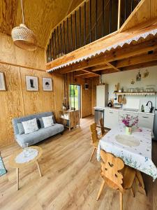 a living room with a table and a couch at Chatka u Radka in Szczodrowo