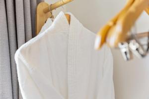 a white shirt hanging on a clothes rack at Glenarch House in Dalkeith