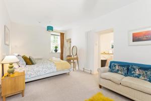 a bedroom with a bed and a couch at Glenarch House in Dalkeith +26 photos