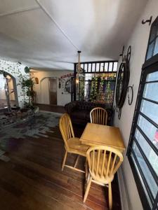 a room with a table and chairs and a couch at Casa Raizal in Envigado
