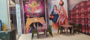 a room with a wall with paintings on it at MR HOTEL & family restaurant Ringus in Rīngas