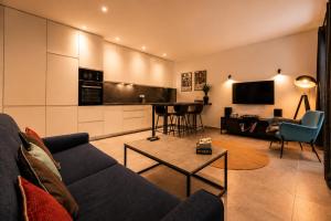 a living room with a couch and a table at Vinyl & Wine Retreat by THE HOUSE Experience Collection in Škaljari