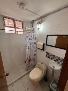 a bathroom with a toilet and a sink at Casa Raizal in Envigado