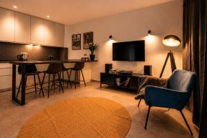 a living room with a kitchen with a table and chairs at Vinyl & Wine Retreat by THE HOUSE Experience Collection in Škaljari