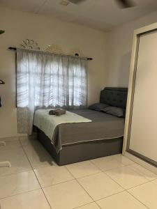 a bedroom with a bed and a window with curtains at Homestay Cinta Kasih Mus'lim Only in Klang +12 photos