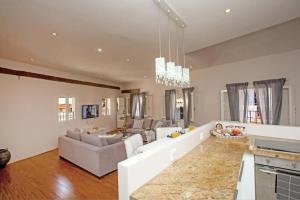a living room with a couch and a table at Guilford Loft in Corfu