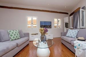 a living room with a couch and a table at Guilford Loft in Corfu