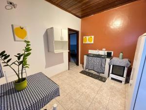 a kitchen with a table and a stove top oven at ACONCHEGO 6 - Self Check-in in Presidente Prudente +27 photos