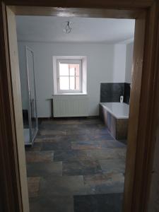 a bathroom with a tub and a sink and a bath tub at Gästehaus Hammerle Holzgau in Holzgau