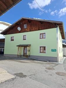 a large white building with a wooden roof at Gästehaus Hammerle Holzgau in Holzgau