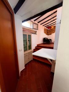 a view of a kitchen with a table and stairs at Mansarda sopra i canali in Piombino