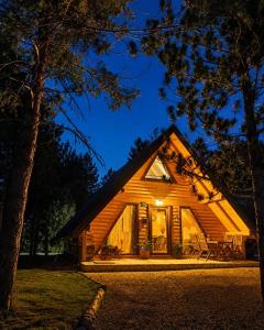 a log cabin at night with the lights on at My Dream - Blidinje in Blidinje
