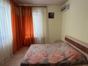 a bedroom with a bed with flowers on it at Мрія in Odesa