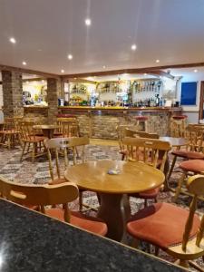 a restaurant with tables and chairs and a bar at Stay 6 - Pool - Parking - BeachSide - Pet Friendly in Trimingham