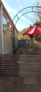 a patio with an umbrella and a table with chairs at Stay 6 - Pool - Parking - BeachSide - Pet Friendly in Trimingham