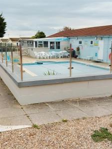 a swimming pool in front of a building at Stay 6 - Pool - Parking - BeachSide - Pet Friendly in Trimingham