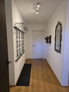 an empty hallway with a mirror and a door at Bella Val (206 Se) in Lenzerheide