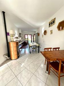 a kitchen and dining room with a table and chairs at La casa di Cleo in Gonnesa +4 photos