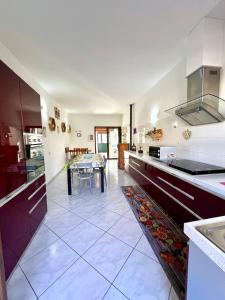 a large kitchen with a table in the middle at La casa di Cleo in Gonnesa