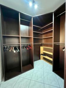 a walk in closet with wooden cabinets at La casa di Cleo in Gonnesa
