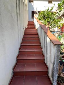 a staircase leading up to a building with red tiles at La casa di Cleo in Gonnesa