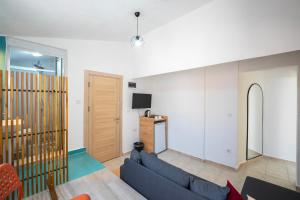 a living room with a blue couch and a kitchen at NEV Fethiye in Fethiye