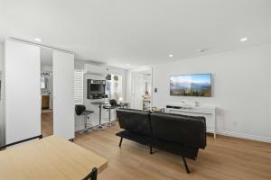 a living room with a couch and a table at Newly Renovated 1BR Suite, Patio BBQ, Fire Pit in Simi Valley +13 photos