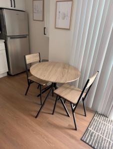 a table and chairs in a kitchen with a refrigerator at Newly Renovated 1BR Suite, Patio BBQ, Fire Pit in Simi Valley