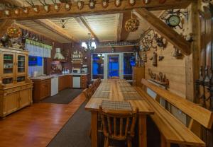 a large kitchen with a long wooden table in it at Sobiesz - Pokoje Gościnne in Jagniątków +31 photos