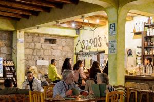 a group of people sitting at tables in a restaurant at IntiRumi Inn in Caraz +54 photos
