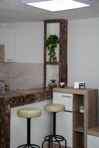 a kitchen with two stools in front of a counter at Zeleni dom in Brestovac