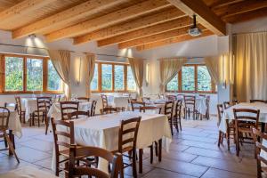 a dining room with tables and chairs and windows at Agriturismo EUCALIPTO in Perdifumo +5 photos