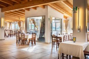 a restaurant with tables and chairs and windows at Agriturismo EUCALIPTO in Perdifumo