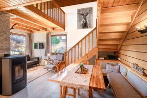 a living room with a table and a couch at Stoderglück by Alpenidyll Apartments in Gröbming