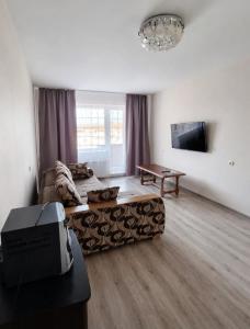 a living room with a couch and a table at Viktorija Apartament in Liepāja