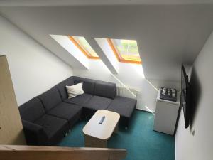 a living room with a couch and a table at Penzion-BelBar Zlín in Zlín