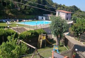 a swimming pool with a slide and a playground at Agriturismo EUCALIPTO in Perdifumo