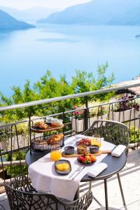 a table with food on top of a balcony at Exclusive Boutique Hotel Elisabetta in Ronco sopra Ascona