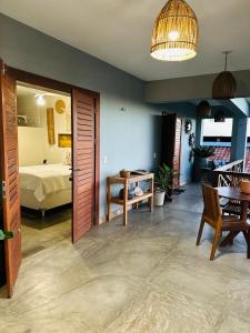 a room with a bedroom with a bed and a table at Casa da dunas in Prea